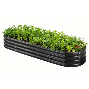 A black, oval-shaped, metal raised garden bed is filled with a variety of green plants and flowers, showcasing efficient space for gardening.
