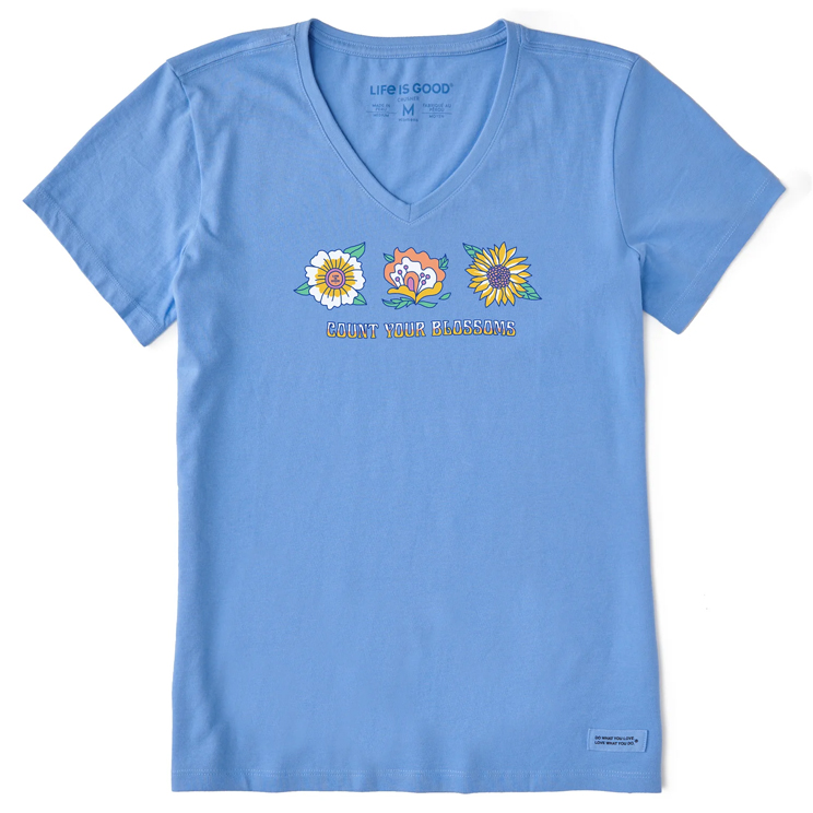 Light blue V-neck T-shirt featuring three colorful flower illustrations and the phrase \“COUNT YOUR BLOSSOMS\“ printed below them. Made by Life is Good.