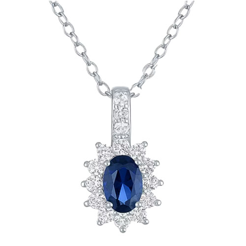 A silver necklace features a pendant with an oval blue gemstone, surrounded by small clear stones in a floral pattern.