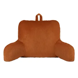 Corduroy bed rest pillow with arms and a carry handle at the top, in an orange color.