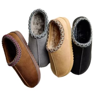 Four pairs of fleece-lined slippers in brown, gray, tan, and black, each featuring a decorative stitched pattern around the opening.