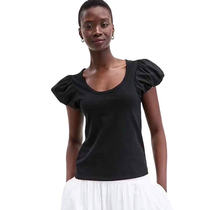 Short-sleeved black top with puffed sleeves paired with a white skirt.