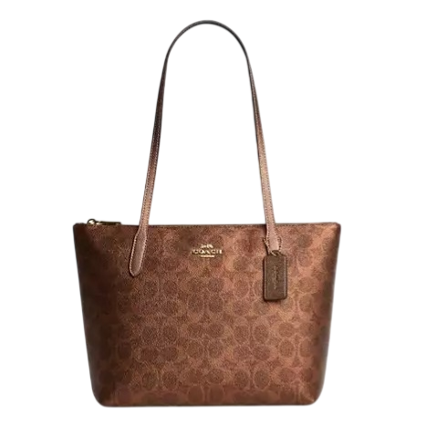 Brown Coach tote bag with signature logo pattern, featuring gold-tone hardware and long handles.