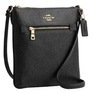 Black Coach crossbody bag with gold-tone hardware and zipper details.