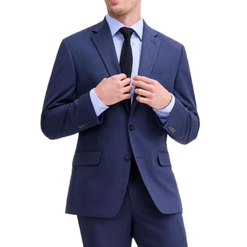 A person is wearing a classic two-button navy suit with a light blue dress shirt and a textured dark tie.