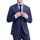 A person is wearing a classic two-button navy suit with a light blue dress shirt and a textured dark tie.