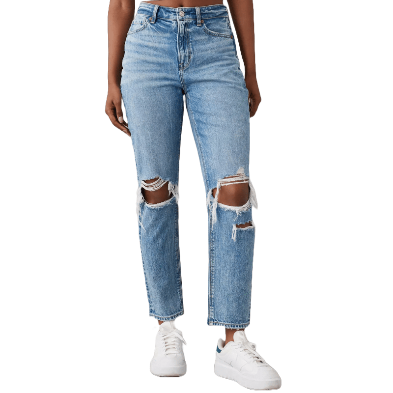 High-waisted mom jeans with a light blue wash and large distressed holes at both knees. They are paired with white sneakers.