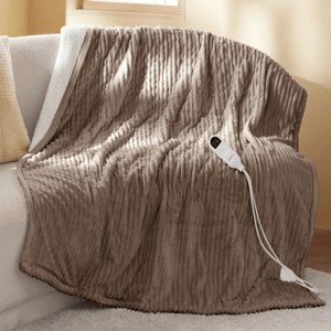 A soft, taupe-colored electric blanket with a textured pattern draped over a couch, featuring a digital control attached by a cord.