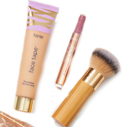 Tarte cosmetics featuring Face Tape foundation, a creaseless concealer in a tube, and a bamboo-handled makeup brush.