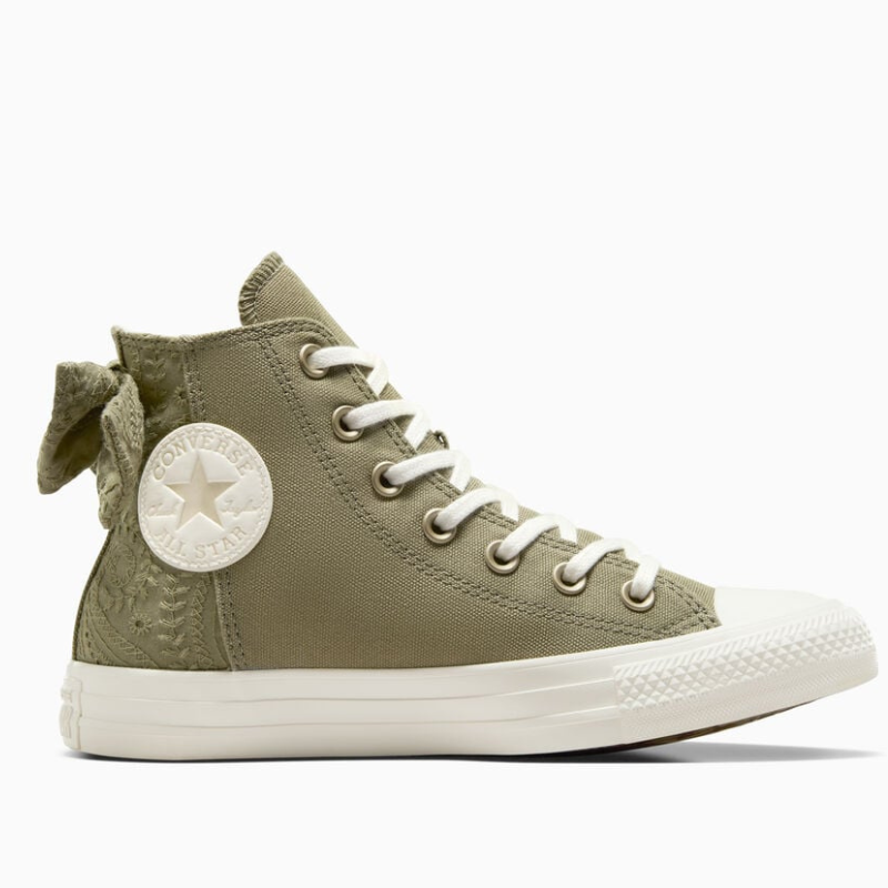 Olive green high-top canvas sneaker with a decorative bow on the back, featuring the iconic Converse All Star logo on the side.