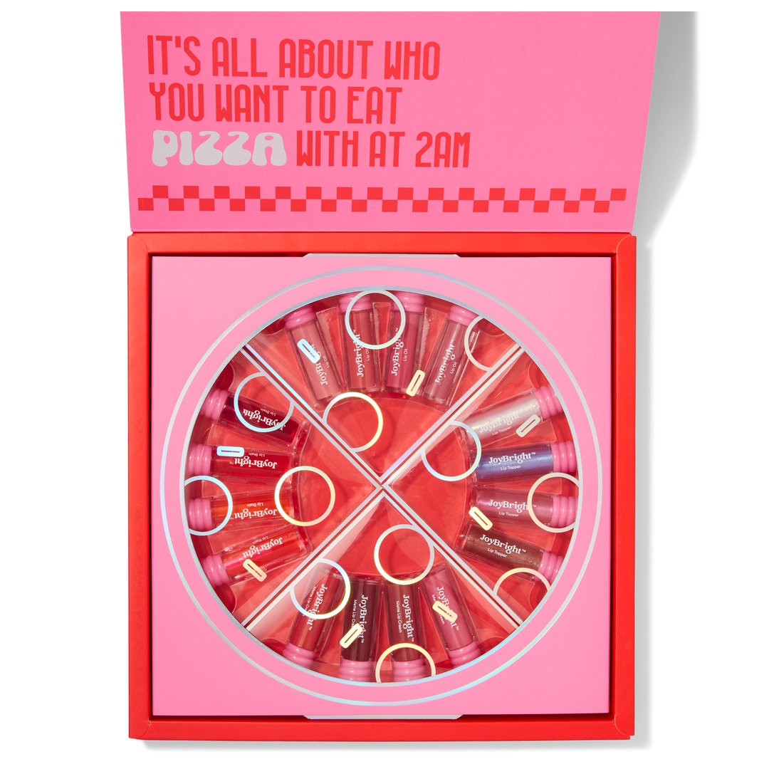The Ulta Beauty Pizza Party Lip Set features 16 lip glosses arranged in a pizza-themed box, with shades varying from pinks to reds. The packaging includes playful text about late-night pizza.