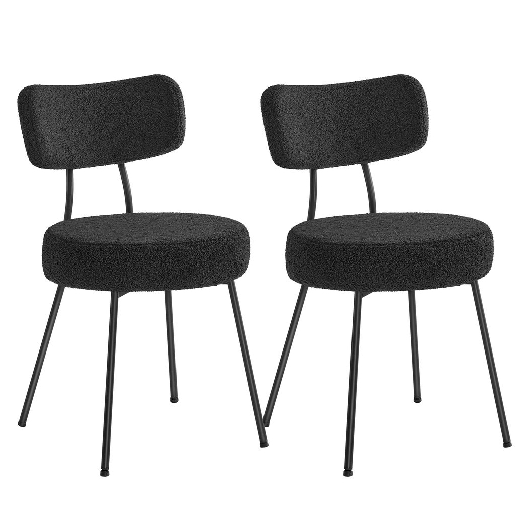 A pair of black fleece dining chairs featuring rounded cushioned seats and backs with sleek, angled metal legs.