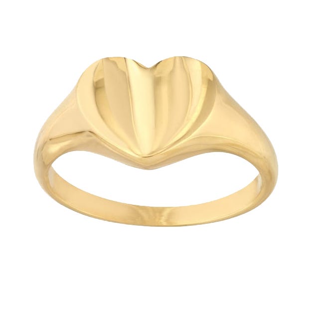 A gold ring with a smooth band features a stylized, raised heart design on top.