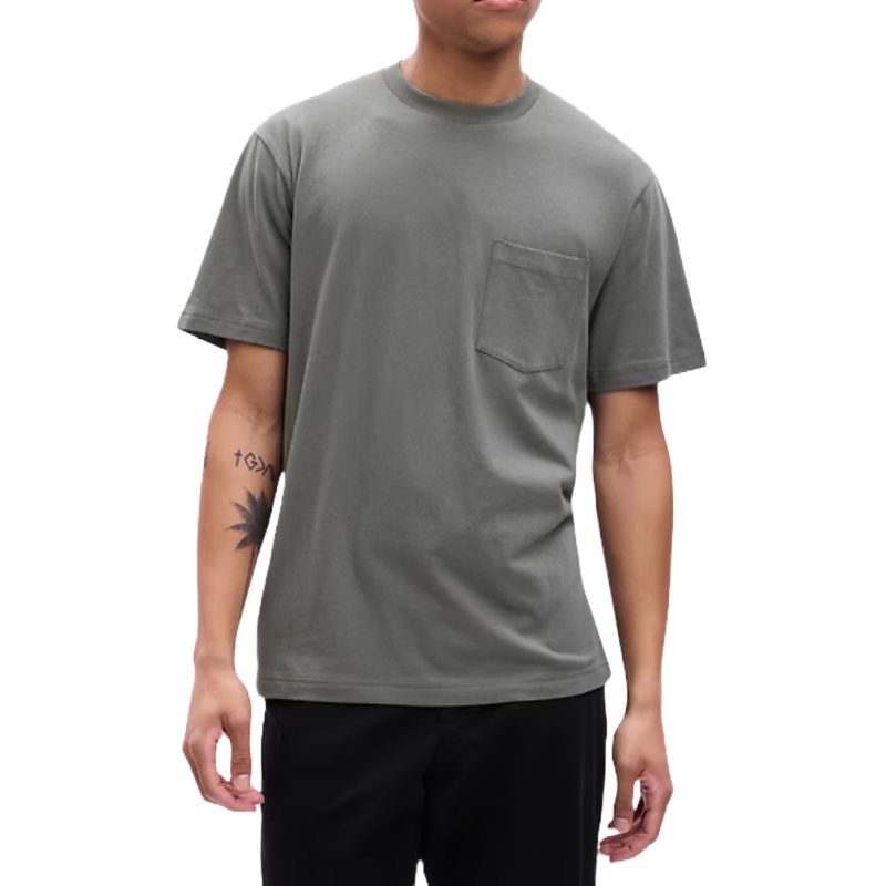 Gray short-sleeve T-shirt with a relaxed fit, featuring a small pocket on the left chest. Worn by a person with visible tattoos on the arms.