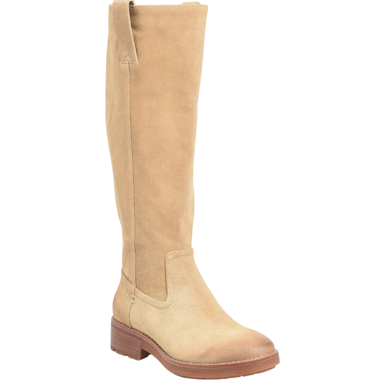 A tan suede knee-high boot with a low stacked heel and a lug sole, featuring a side pull tab for easy wear.