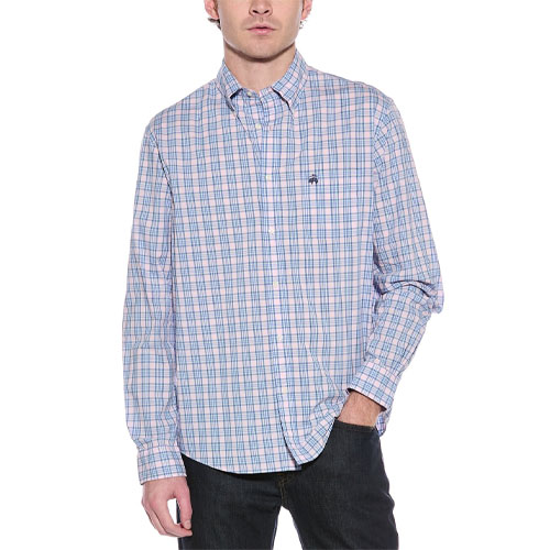 A man is wearing a Brooks Brothers long-sleeve button-down shirt with a light blue and pink checkered pattern, featuring a subtle logo on the chest. He's paired it with dark jeans.