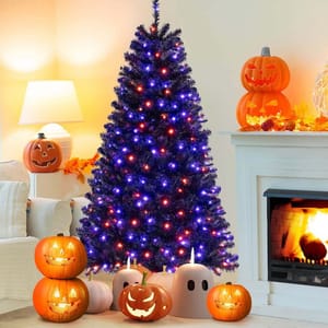 A black Christmas tree with purple and orange lights is surrounded by lit jack-o'-lanterns and ghost decorations, placed near a fireplace and other Halloween-themed decor.