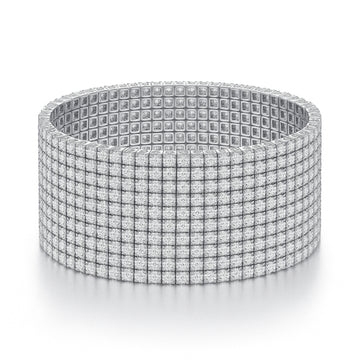 A wide, silver-toned bracelet featuring a grid design with small, square embellishments covering its surface.