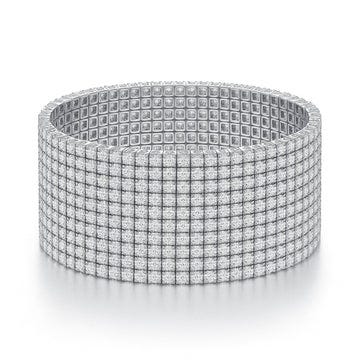 A wide, silver-toned bracelet featuring a grid design with small, square embellishments covering its surface.