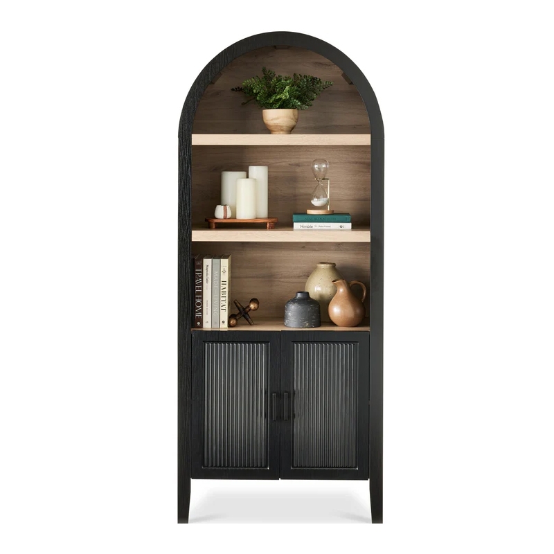 Arched 5-tier cabinet with a black frame and reeded glass doors; features three open shelves with décor items like plants, candles, books, an hourglass, and ceramic pieces.