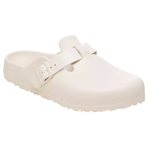 A cream-colored clog sandal with a buckle strap and textured sole, designed for casual wear.