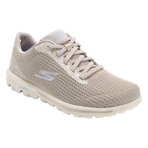 Skechers Go Walk Slip Ons feature a light beige mesh upper with floral accents, a lace-up design, and a supportive, cushioned sole designed for comfort and ease when walking.