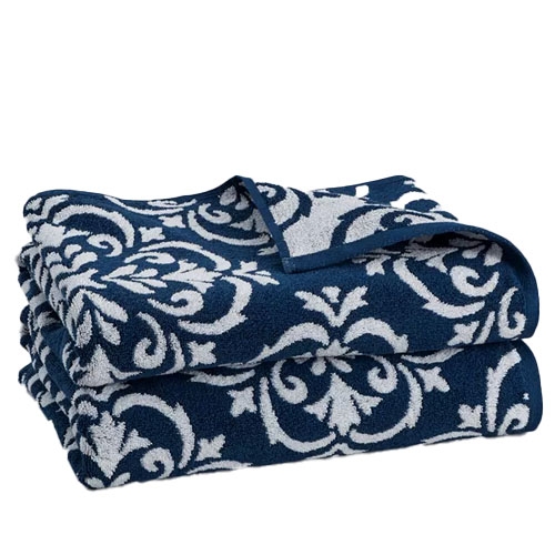 A two-piece bath towel set with a dark blue background and a white intricate damask pattern. The edges are neatly hemmed for durability and style.