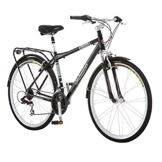 A black Schwinn hybrid bicycle with front suspension, fenders, a rear rack, and multiple gears.