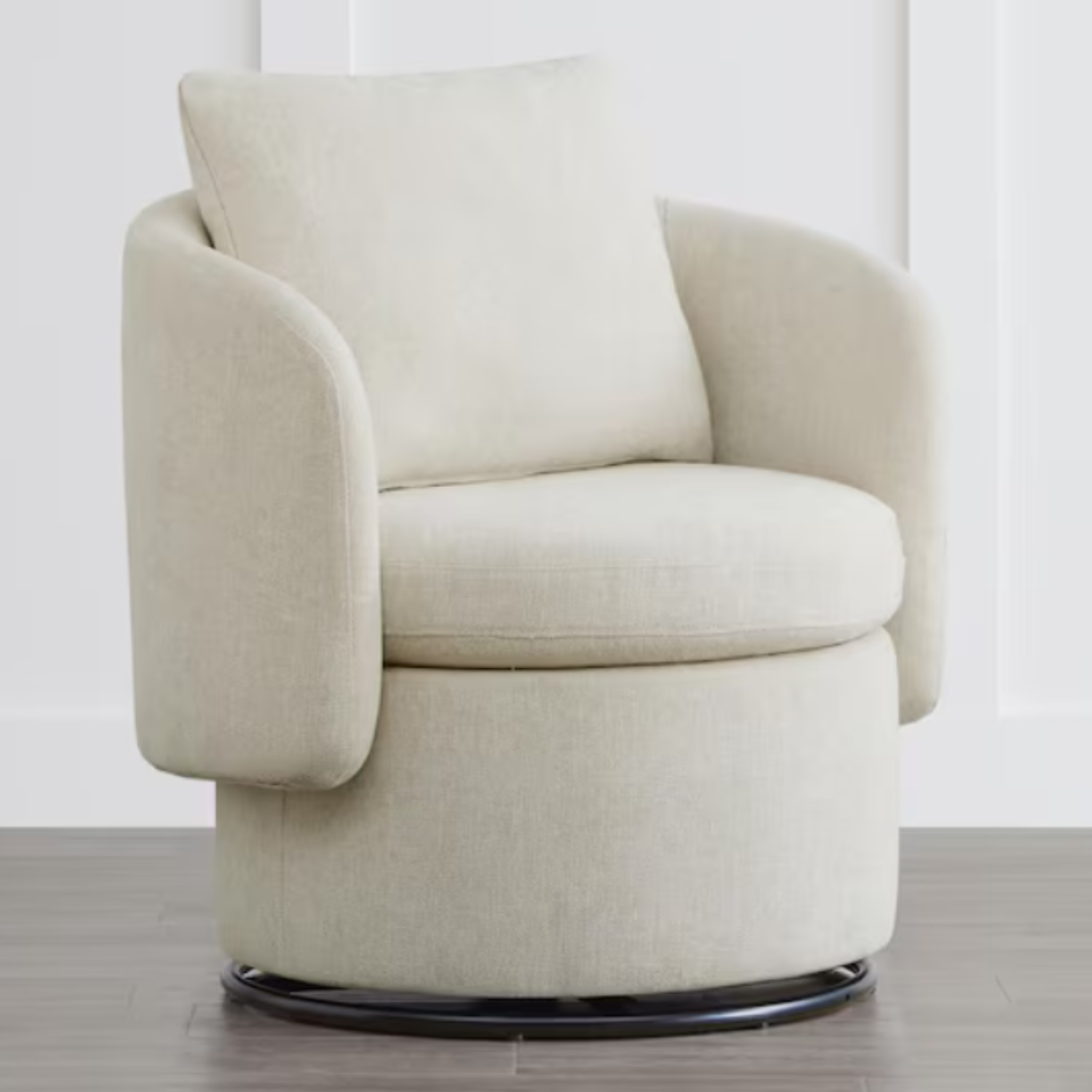 A cream-colored swivel accent chair with a rounded back and arm design, featuring a cylindrical base with discreet storage. The chair includes a plush back cushion for added comfort.