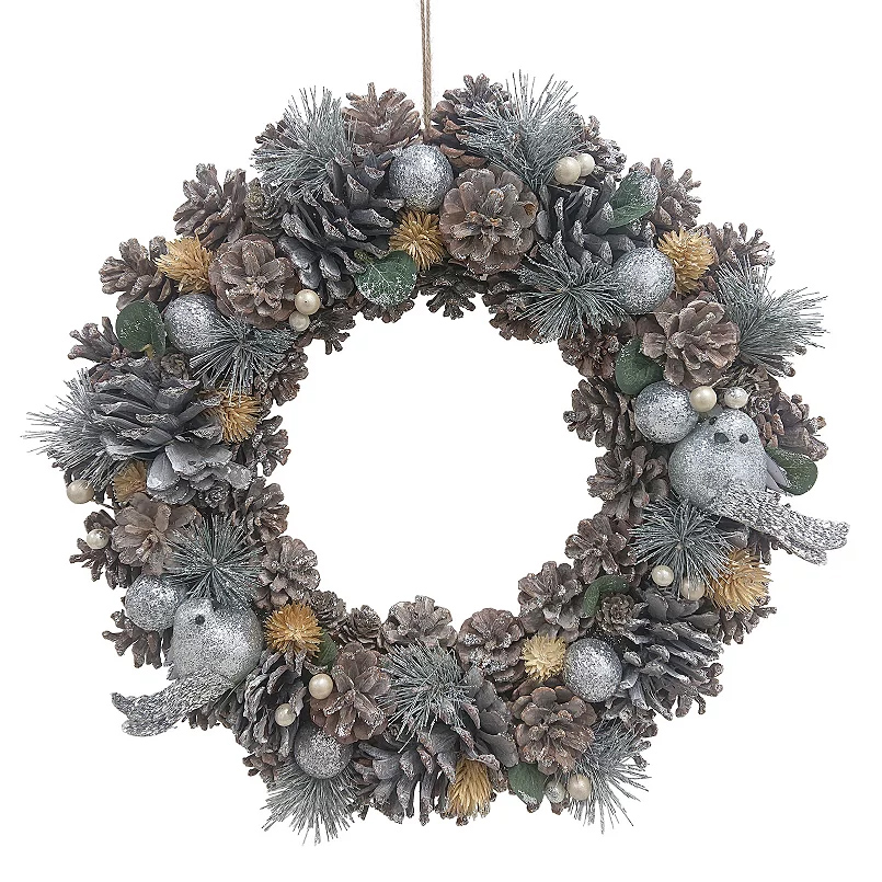 A festive wreath featuring frosted pinecones, glittery silver baubles, faux greenery, pearl accents, and decorative birds, creating a snowy, wintery appearance.