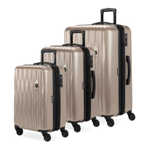A three-piece set of gold hardshell luggage with four spinner wheels and telescopic handles in varying sizes.