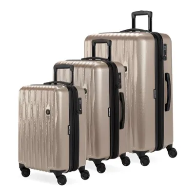 A three-piece set of gold hardshell luggage with four spinner wheels and telescopic handles in varying sizes.