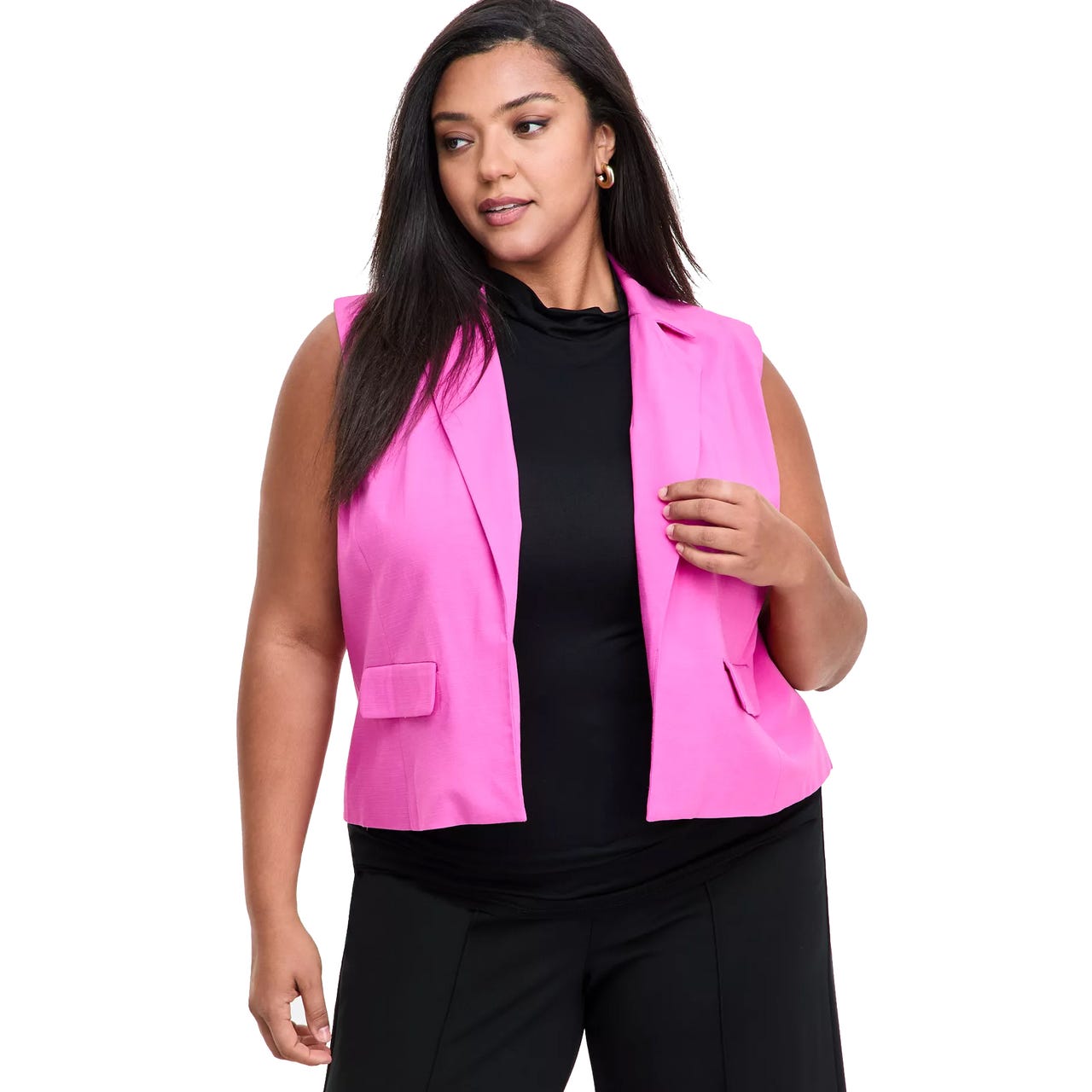 A woman is wearing a bright pink sleeveless blazer over a black shirt and black pants.