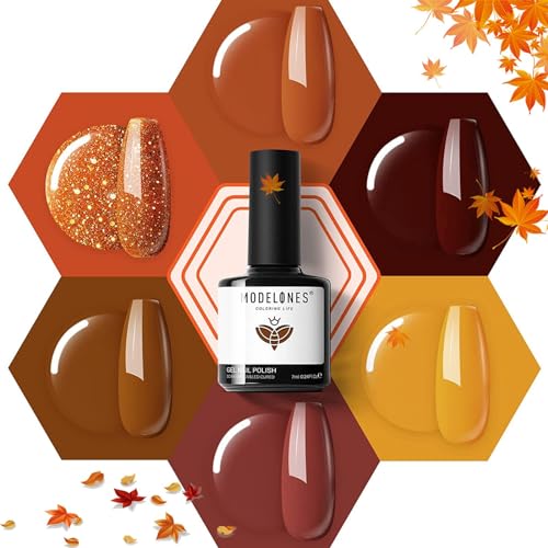A collection of six gel nail polishes in autumnal shades, ranging from glittery gold to warm tones of brown, amber, and red, with leaf accents suggesting a fall theme.