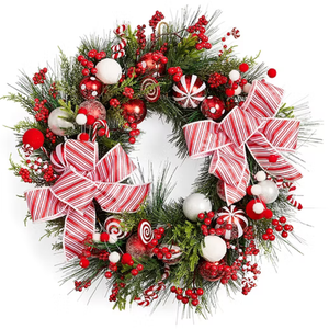 A festive Christmas wreath decorated with red and white striped bows, candy-themed ornaments, berries, and pine greenery.