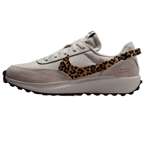 A beige sneaker with a leopard print swoosh, featuring suede and textile materials, and a rugged black outsole.