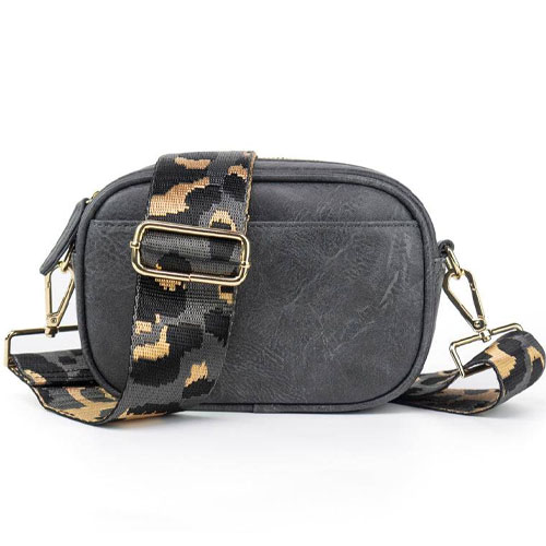 A small black crossbody bag with a gold clasp and a detachable strap featuring a camouflage pattern in black and tan.