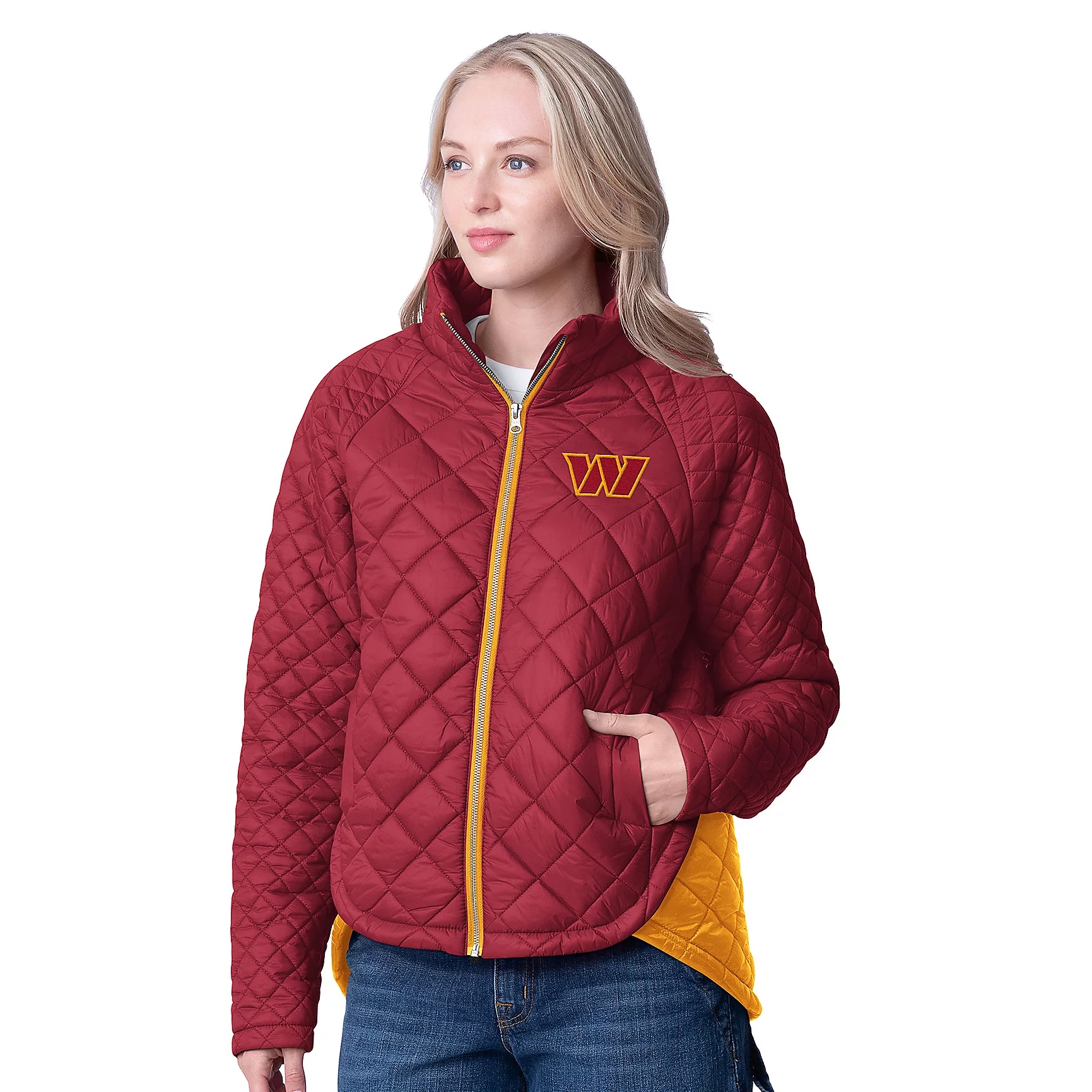A woman wears a quilted NFL jacket in burgundy and gold. It features a \“W\“ logo on the chest, yellow zipper, curved hem, and a contrasting yellow inner lining, paired with jeans.