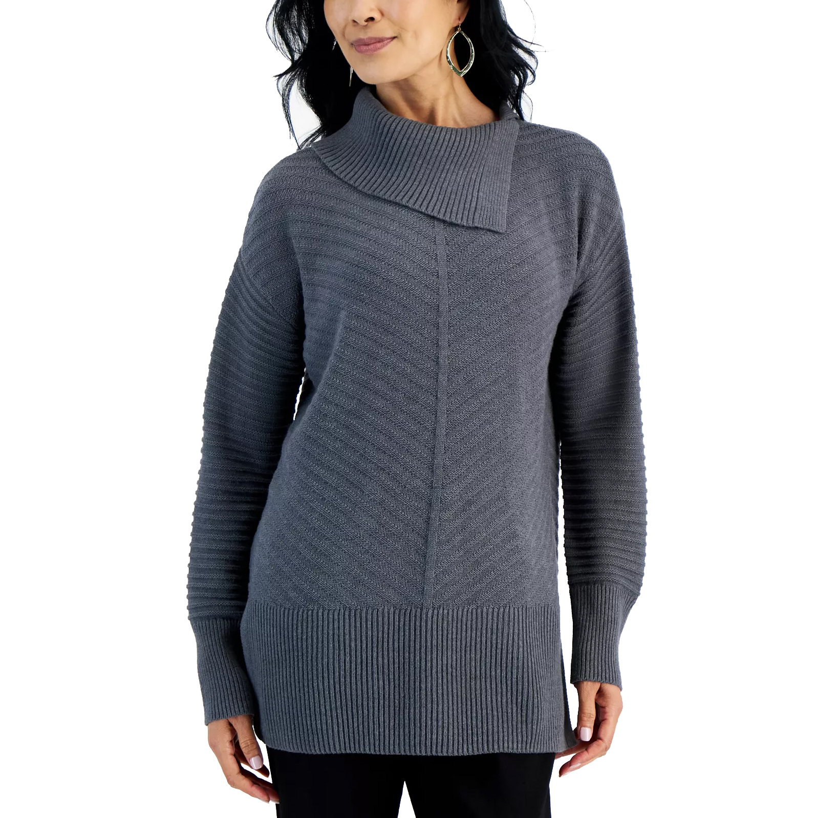 A woman is wearing a gray knit sweater with an asymmetric collar and ribbed detailing on the sleeves and hem, paired with black pants.