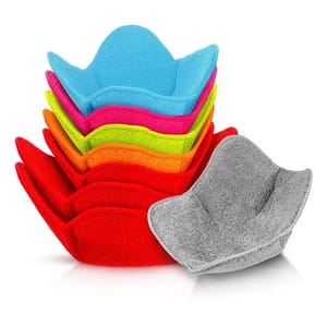 Set of colorful, soft bowl and plate huggers designed to protect hands from hot or cold dishes. The stack includes blue, pink, yellow, orange, red, and gray huggers, each with a rounded rectangular shape and snug fit for various dishes.