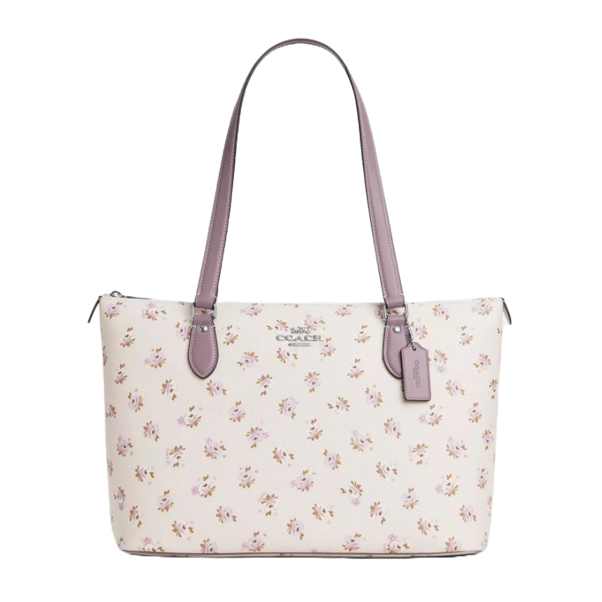 Coach Gallery Tote Bag in signature canvas features a floral print with lavender handles and accents, zip-top closure, and a Coach tag.