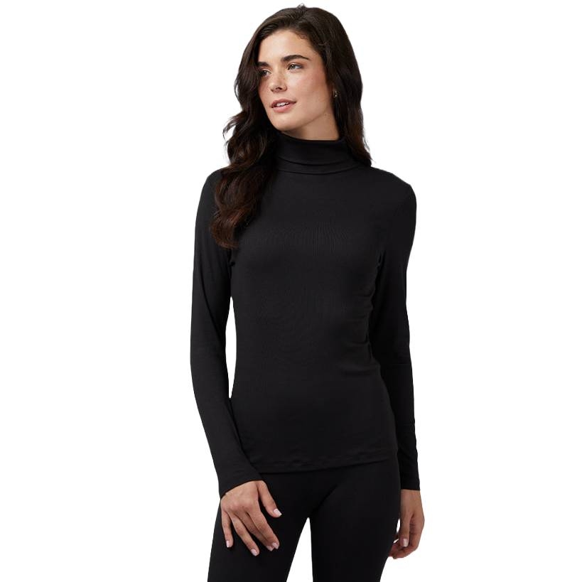 A woman is wearing a black 32 Degrees Soft Rib Turtleneck with long sleeves, a fitted design, and a high neck, perfect for layering or wearing alone.