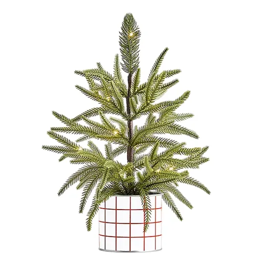 A small artificial Christmas tree with green pine needles in a pot with a red grid pattern, featuring subtle integrated lights, suitable for indoor holiday decor.