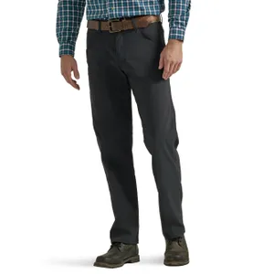 A man wearing black trousers, a plaid shirt, a brown belt, and brown boots.