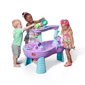 Three children are playing with a purple and blue water table that has a variety of water toys and accessories on it.