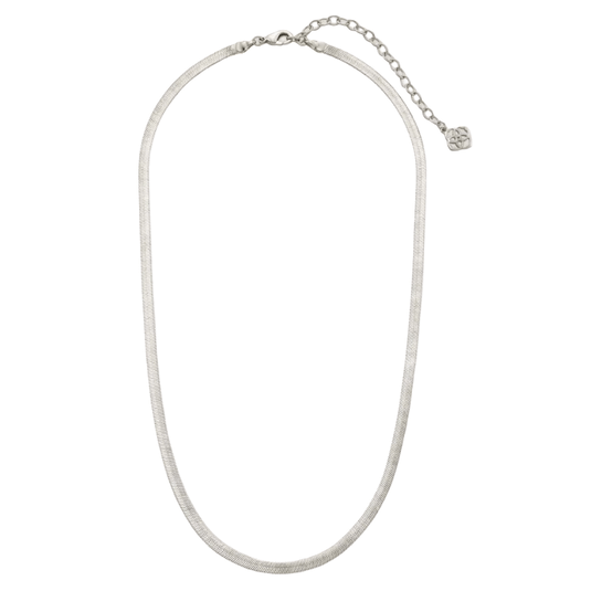 A silver-toned snake chain necklace with an adjustable clasp and a small decorative charm at the end of the extender chain.