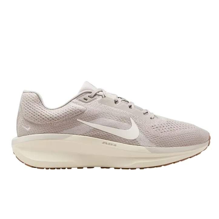 A light beige Nike running shoe with a white swoosh logo, featuring a cushioned sole designed for comfort and support.
