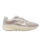 A light beige Nike running shoe with a white swoosh logo, featuring a cushioned sole designed for comfort and support.