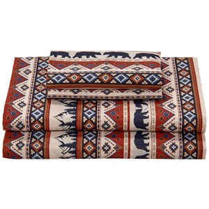 A microfiber sheet set with a rustic lodge pattern featuring bears and trees, along with geometric designs in earthy tones of red, blue, and cream.