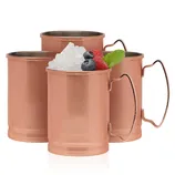 Three copper mugs with handles are shown. One is filled with crushed ice, topped with raspberries, blueberries, and a mint leaf.
